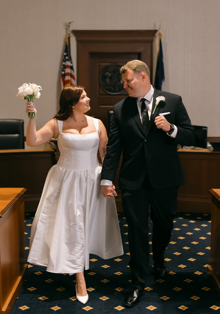 Bride and groom celebrating after courthouse wedding