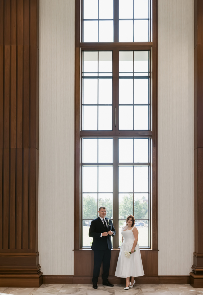 Bride and groom beneath courthouse windows in Spartanburg