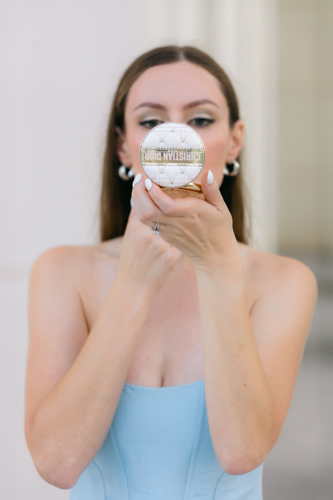 Bride holding Dior compact mirror