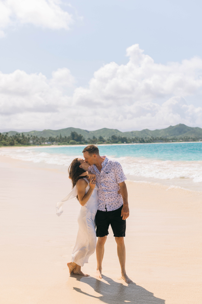 Bride and groom kissing on an Oahu beach