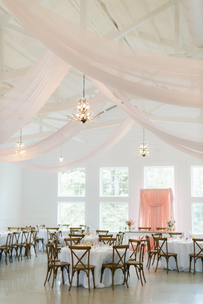 Pink draped ceiling wedding reception