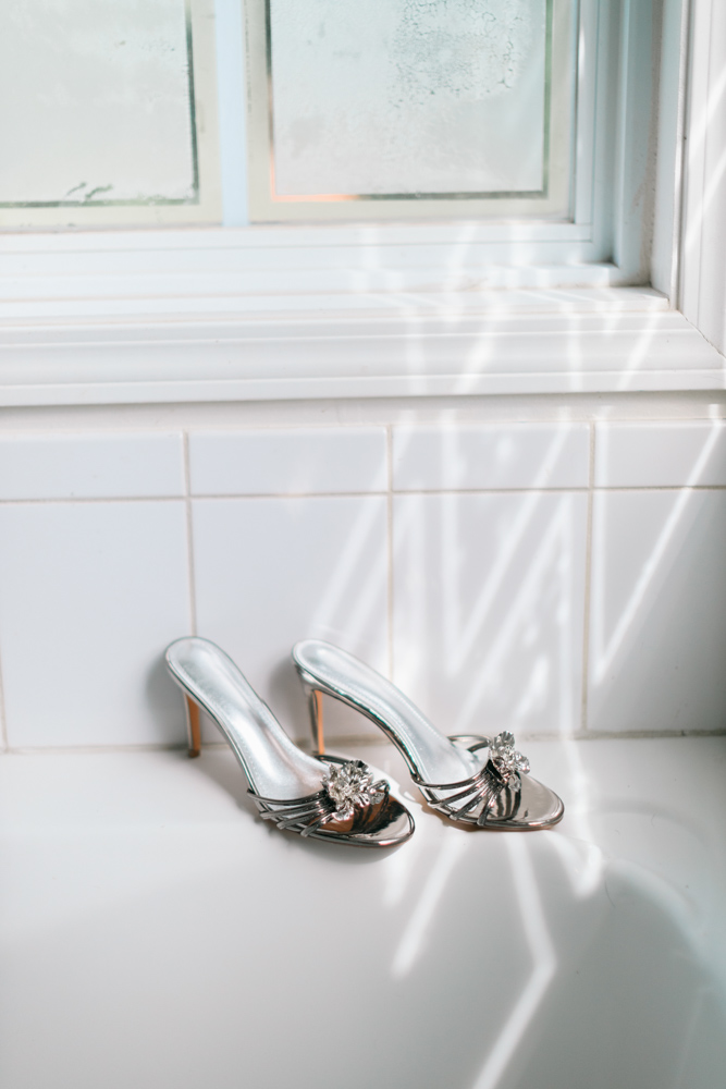 Silver bridal heels in window light