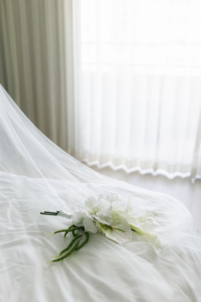 White tropical bridal bouquet on wedding veil