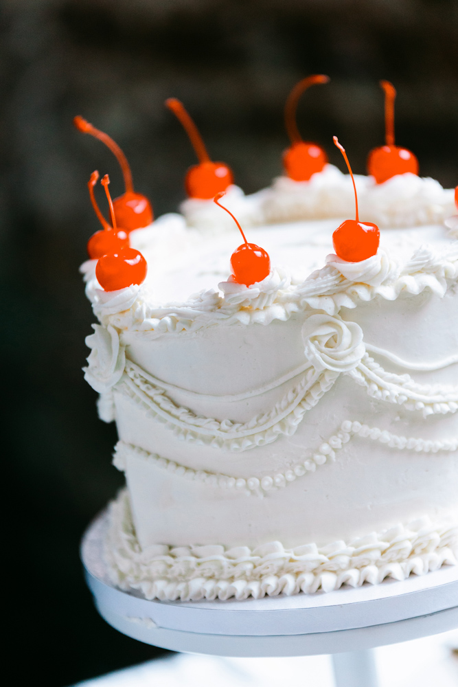 Vintage white wedding cake with cherries