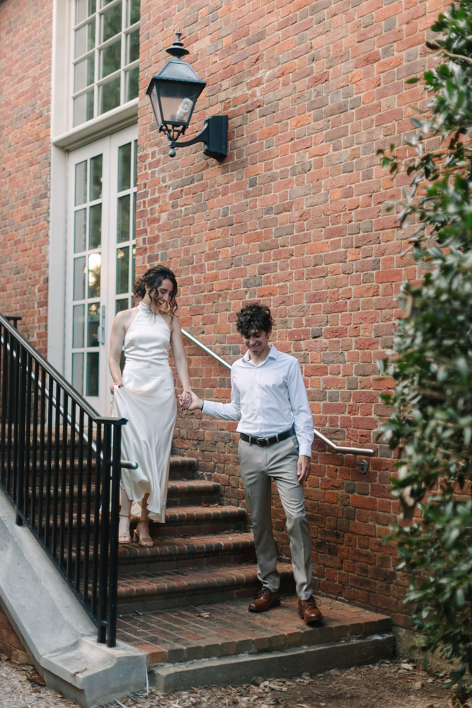 Couple walking down brick steps at Furman