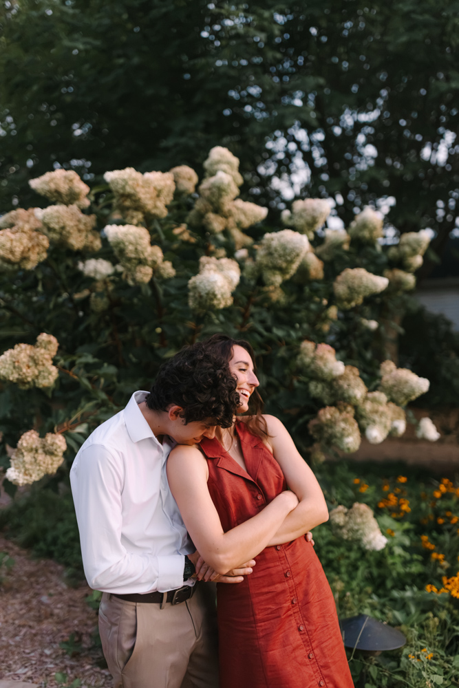 Couple laughing among Furman hydrangeas