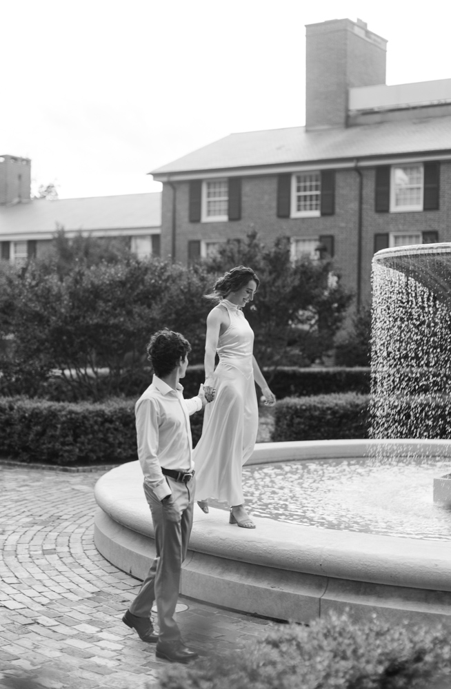 Couple walking together beside Furman fountain