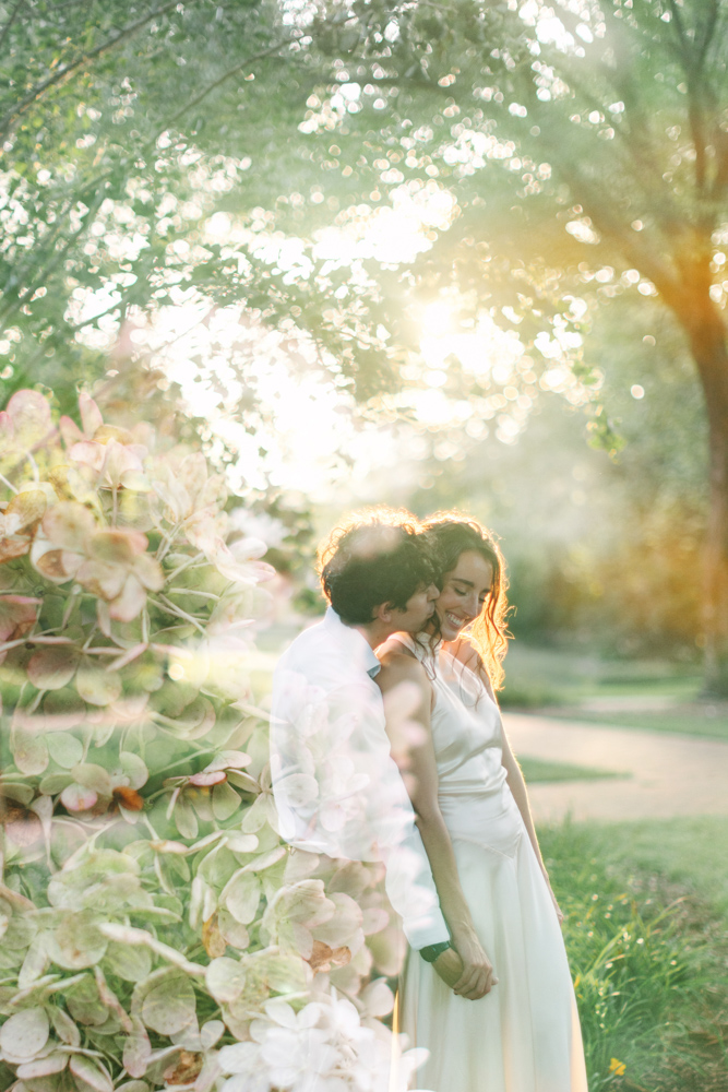 Couple embracing in Furman gardens at sunset