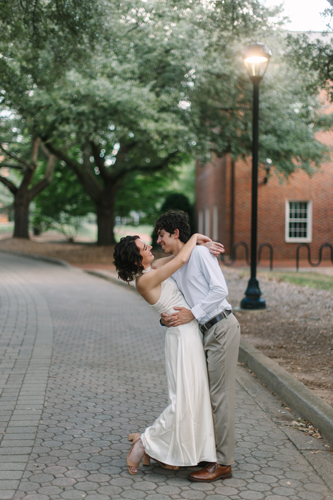 Engaged couple laughing together at Furman University