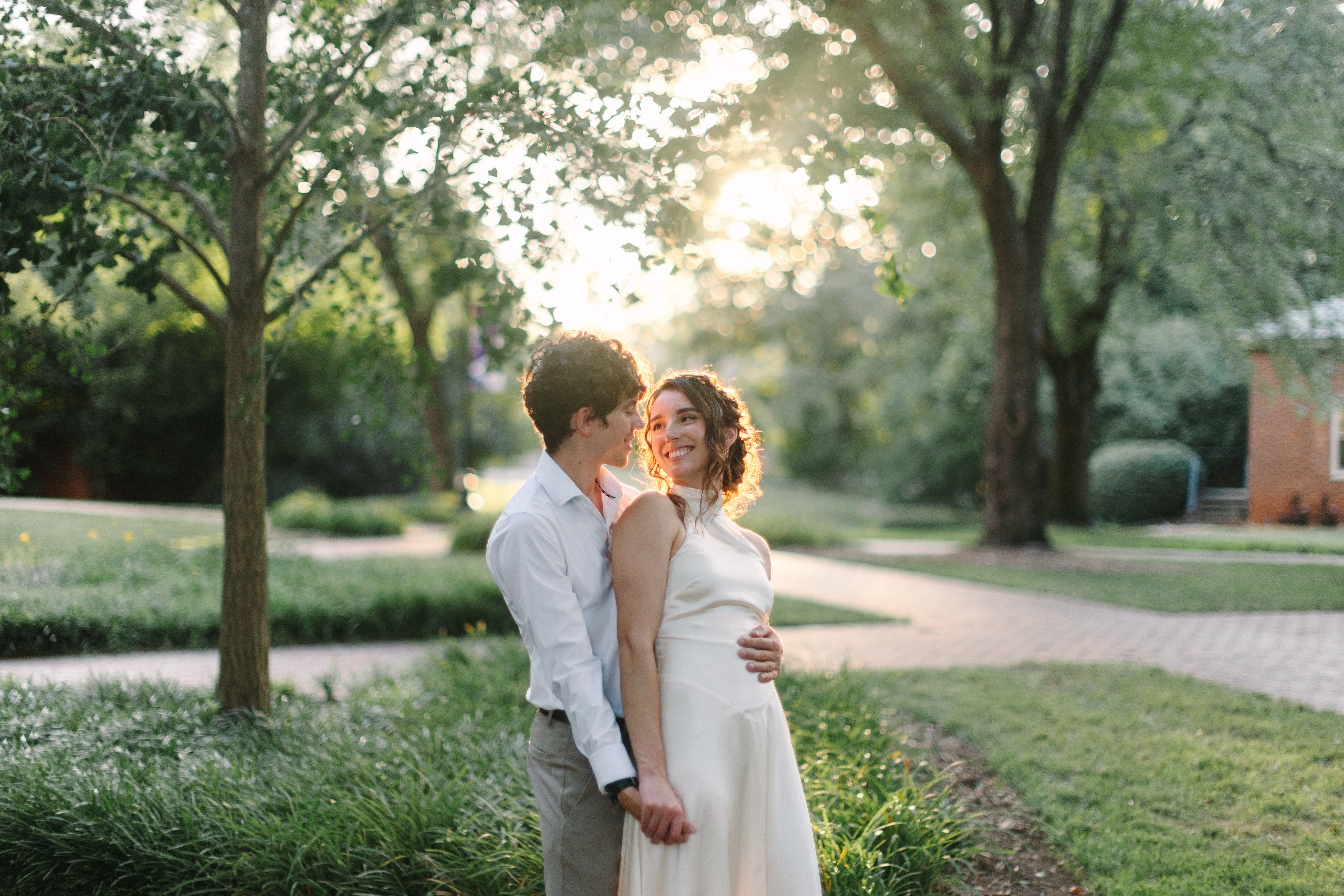 Couple laughing with each other at Furman University during sunset.